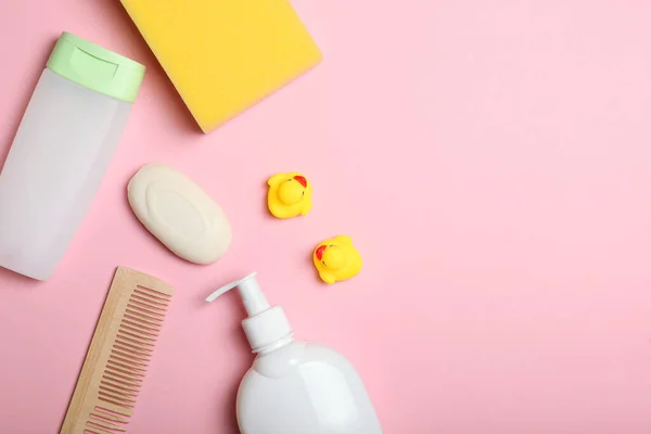 Baby care products on a colored background top view. Daily baby care products for skin care, for bathing. Hygiene of the newborn.