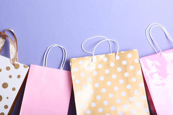 packages for shopping on a colored background top view. Minimalism, place for text.