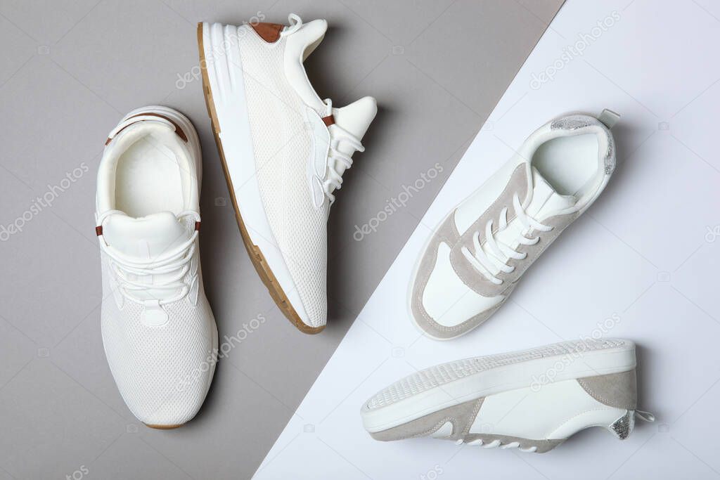 Men's and women's sneakers on a colored background top view. Sport shoes. White running shoes