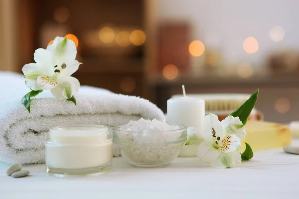 spa composition with towels and flowers on the table with place for text. Body care, relaxation