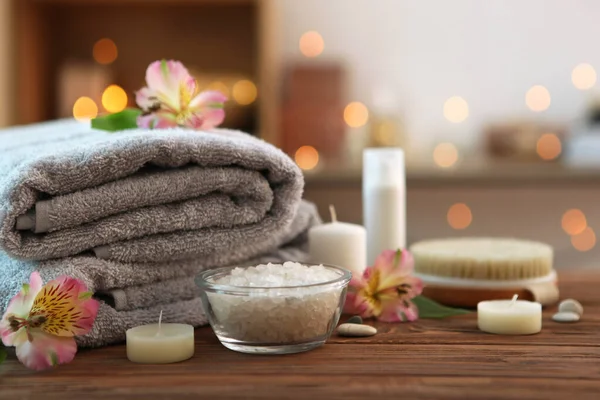 spa composition with towels and flowers on the table with place for text. Body care, relaxation