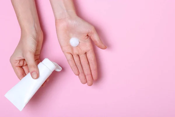 girl smears her hands cosmetic cream. skin care, elastic and young skin of the hands.