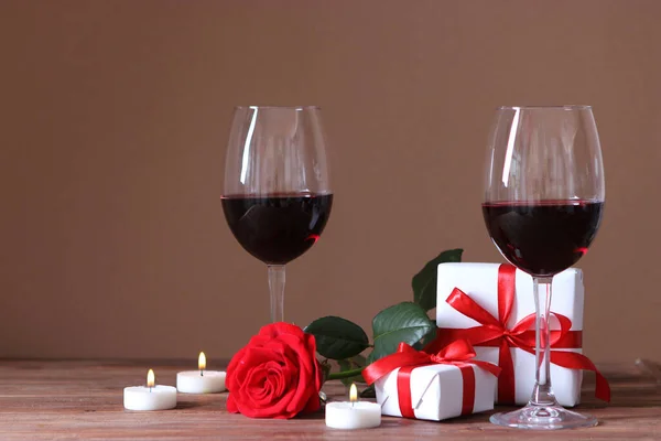 red wine and roses on the table. Valentine\'s day background. A gala dinner for two.