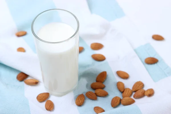 Almond milk and almonds on the table. Vegetable milk. Vegetarian milk.