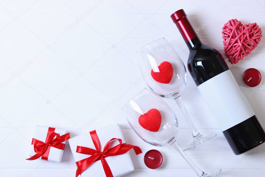 Glasses and hearts on a colored background top view. Valentine's day background.