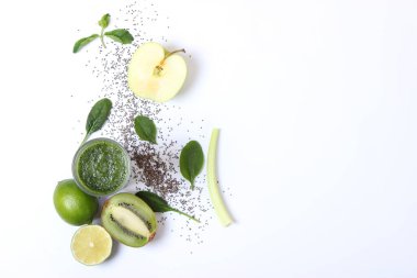 Arınma organizması için yeşil meyve püresi ve taze sebzeler masada.