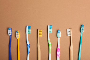 Renkli arka plan görünümlü doğal bambu diş fırçaları ve plastik..