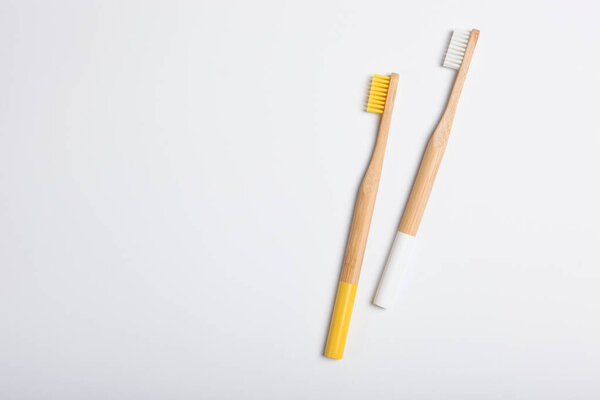 natural bamboo toothbrushes on a light background top view. Oral and dental care.