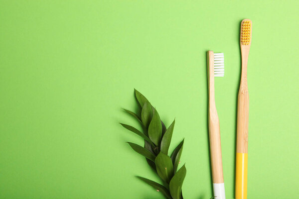 natural bamboo toothbrushes on a colored background top view. Oral and dental care.