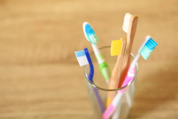 Natural bamboo and plastic toothbrushes on the table.