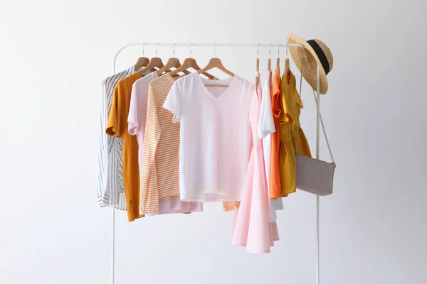 fashion clothes on a stand in a light background indoors. place for text