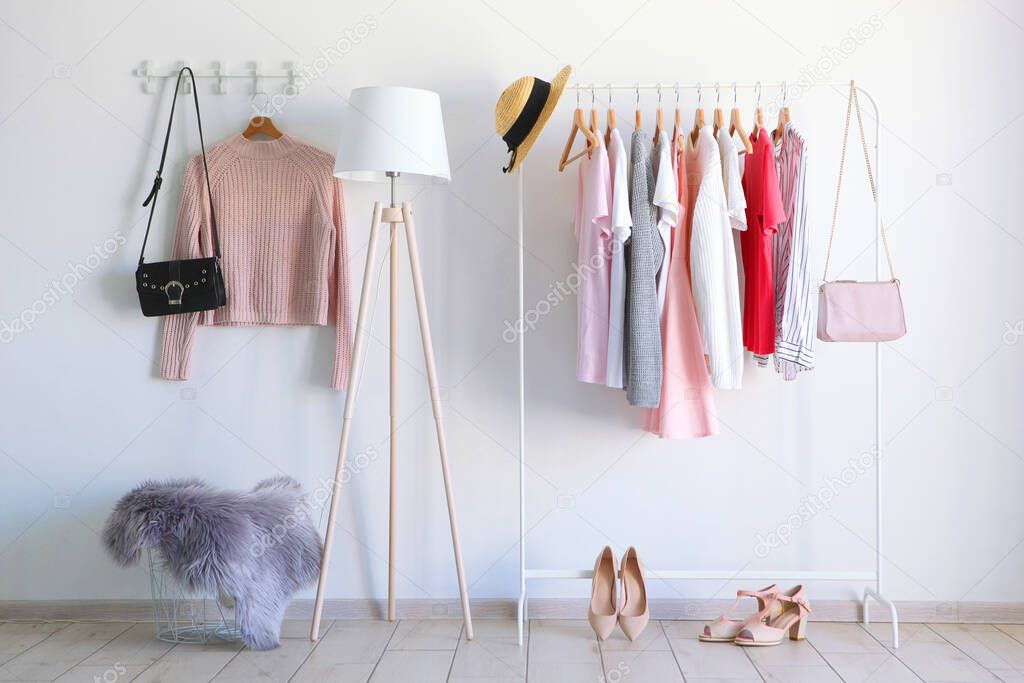 fashionable clothes on a rack in a bright interior of the wardrobe room