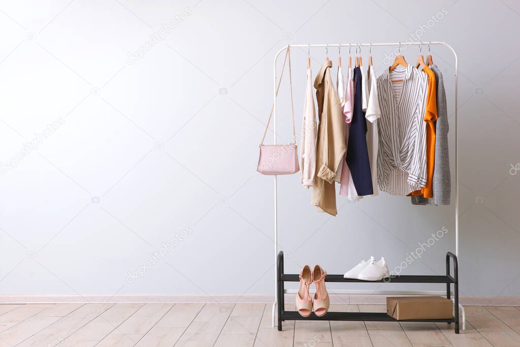 fashion clothes on a rack in a light background indoors. place for text