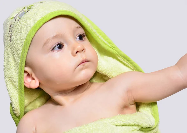 Portrait of an adorable baby boy wearing a towel after bath. — Stock Photo, Image