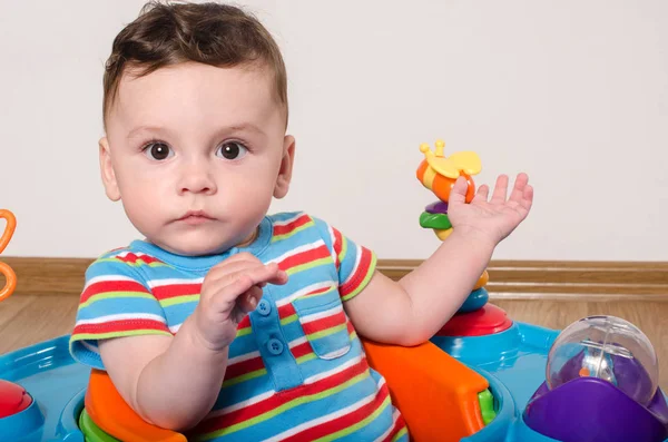 Cute baby boy sitting and playing with toys. — Stock Photo, Image