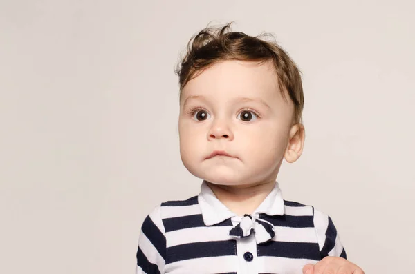 Portrait of a cute baby boy looking away surprised with his big eyes. — Stok Foto