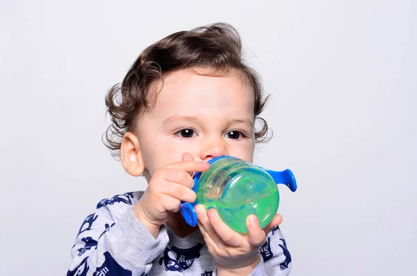 Porträt eines niedlichen Kleinkindes, das Wasser aus der Flasche trinkt. — Stockfoto