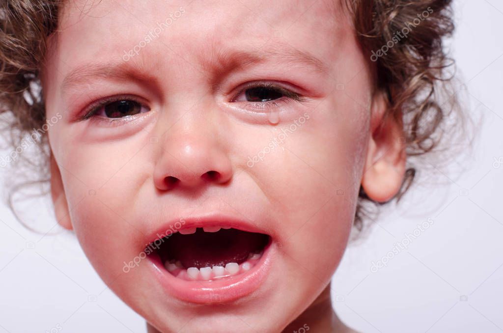 Portrait of a baby boy upset crying.