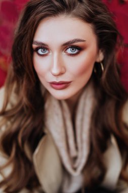 Sonbahar yapraklarının arka planında moda kadını