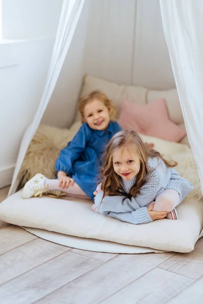 Sisters share gossips having fun at home.