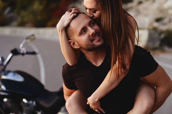 Couple of lovers kissing and hugging on motorbike — Stock Photo, Image