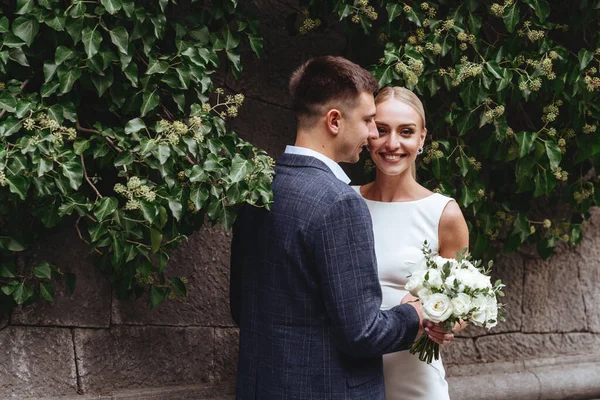 Happy bride and groom near old castle — Stock Photo, Image