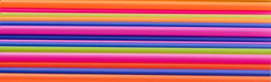 banner of colored tubules for juice and cocktails on pink background.