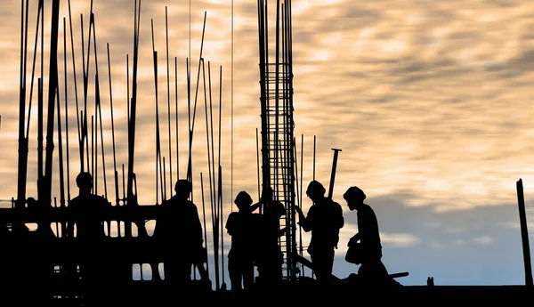 Construction worker silhouette on the work place — Stock Photo, Image