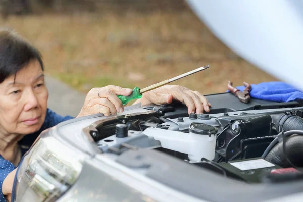 Mujer mayor reparando su coche —  Fotos de Stock