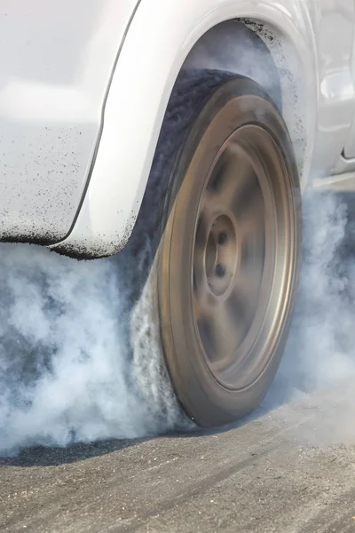 Arrastre coche de carreras quema caucho de sus neumáticos en preparación para la carrera —  Fotos de Stock