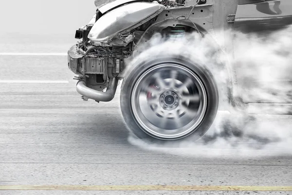 Race car burns rubber off its tires in preparation for the race — Stok fotoğraf