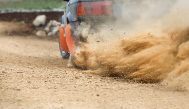 Rally Car turning in dirt track clipart