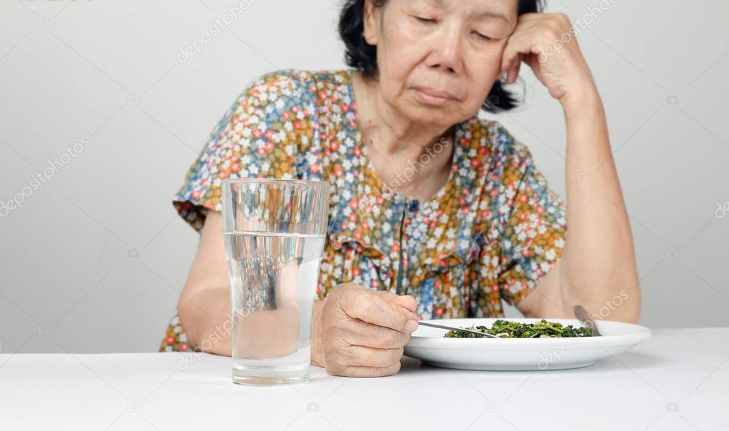 Elderly asian woman bored with food — Stock Photo © toa55 #158172092