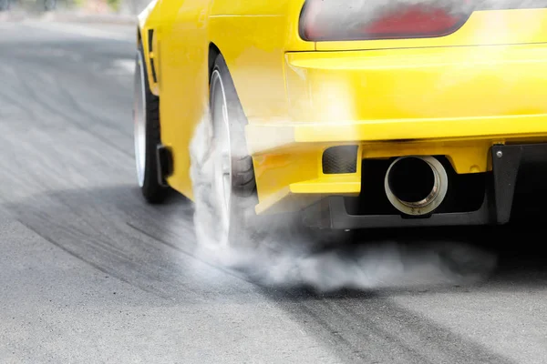 Race car burns rubber off its tires in preparation for the race — Stok fotoğraf
