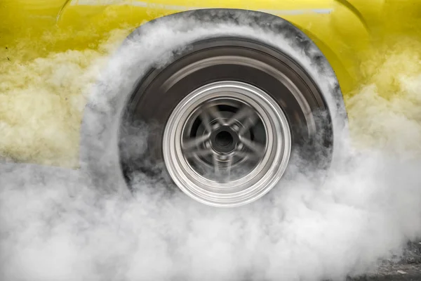 Drag racing car burns rubber off its tires in preparation for the race — Stock Photo, Image