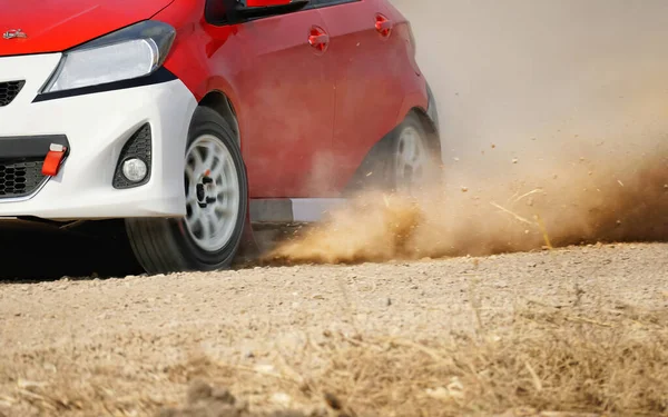 Rally racing car on dirt road.