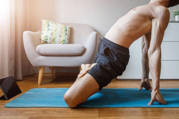 Man practicing yoga at home with online yoga class — Stock Photo, Image