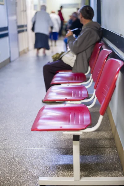 Primer plano en Sillas para pacientes y visitantes en el hospital, personas desenfocadas — Foto de Stock