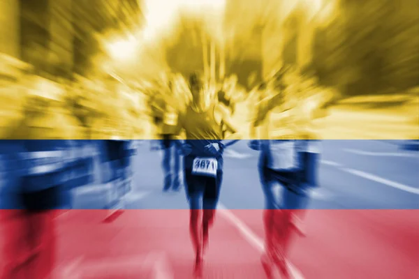 Maratón corredor movimiento borroso con la mezcla de la bandera de Colombia — Foto de Stock