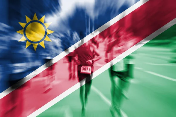 Maratón corredor movimiento borroso con mezcla de la bandera de Namibia — Foto de Stock