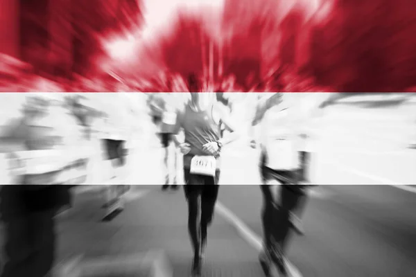 Marathon-loper bewegingsonscherpte met het mengen van de vlag van Jemen — Stockfoto