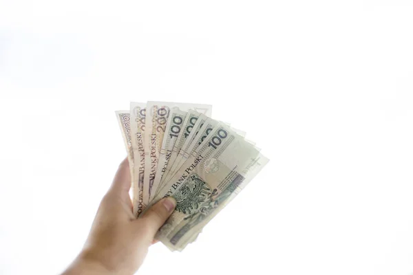 Lengyel pln pénz a kezét, fehér háttér — Stock Fotó