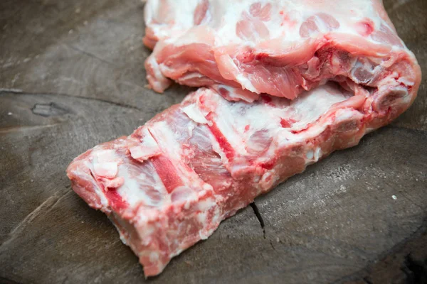 Raw pork ribs on natural wood background — Stock Photo, Image