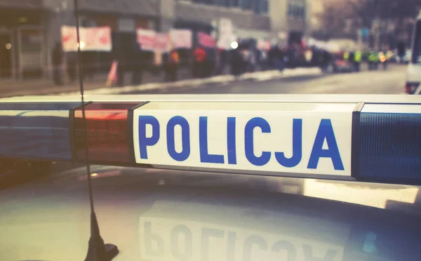 Detail of a police (Policja) car in Poland, demonstration in bac — Stock Photo, Image