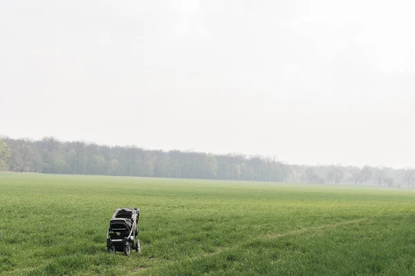 Stroller left in the field, child lost Stock Picture