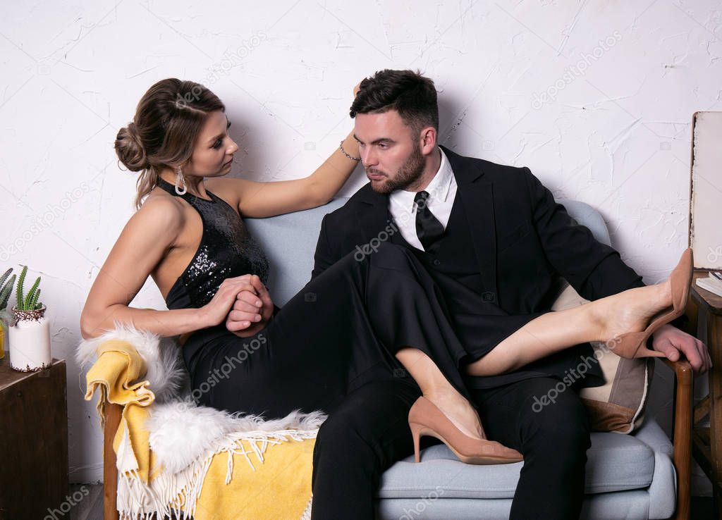 beautiful girl adjusts her hair for a tired man businessman, retro photo