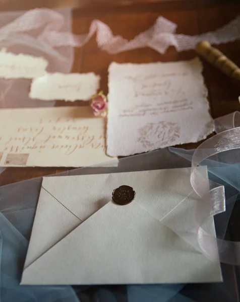 A paper letter with a sealing wax seal for sending prepared wedding invitations. Wedding concept