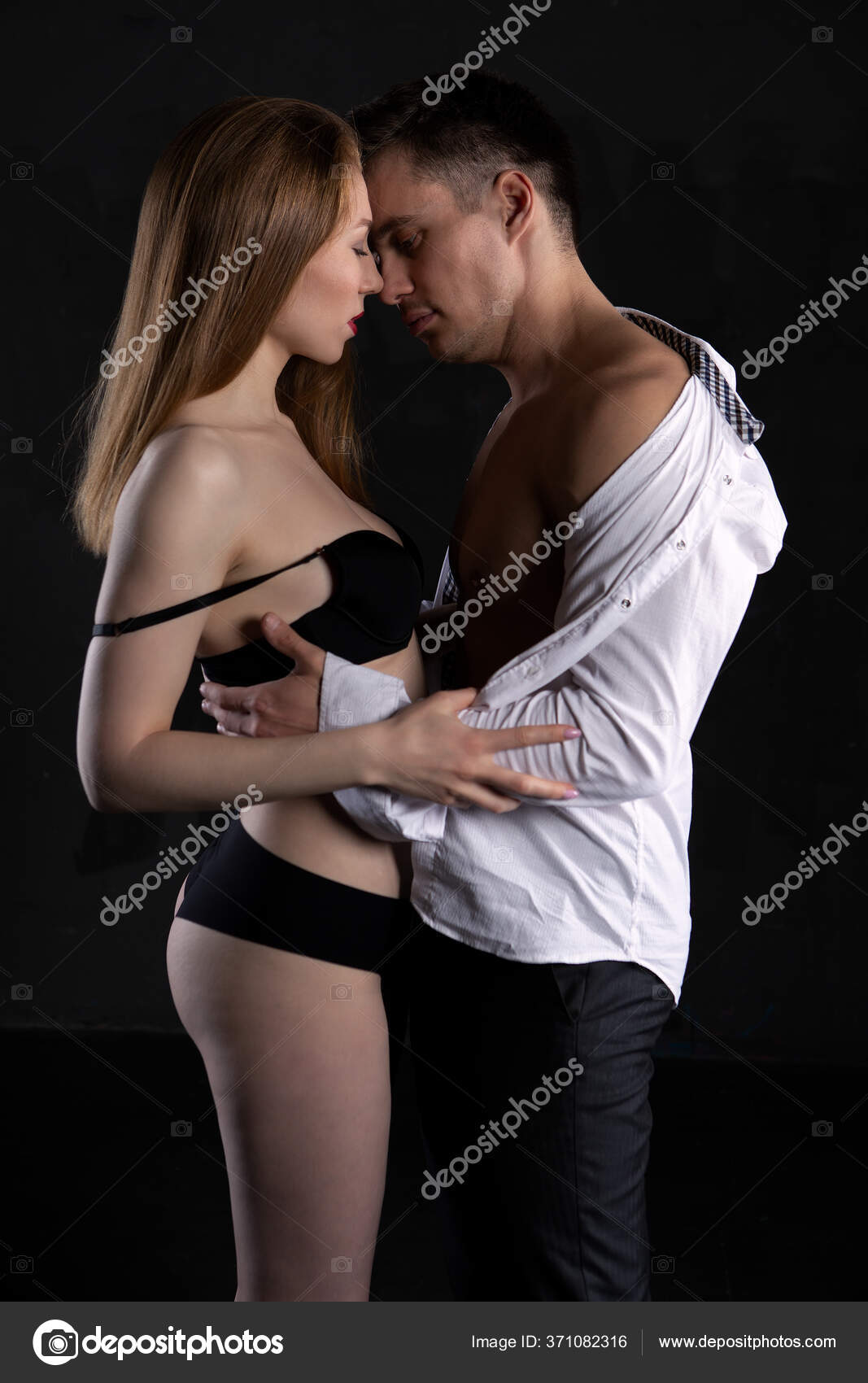 Side view of a young naughty lady in seductive lingerie, passionately kissing her lover in a dark room, going to have sex Stock Photo by ©IvanovDenis43 371082316 photo