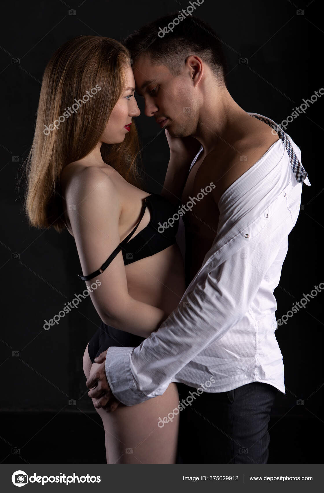Couple Having Sex, Man Take Off Bra Of Girl In His Lap Stock Photo