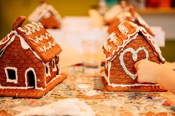 cooking gingerbread cookies, a house of cookies for Santa, kids are preparing to eat, decorating the house